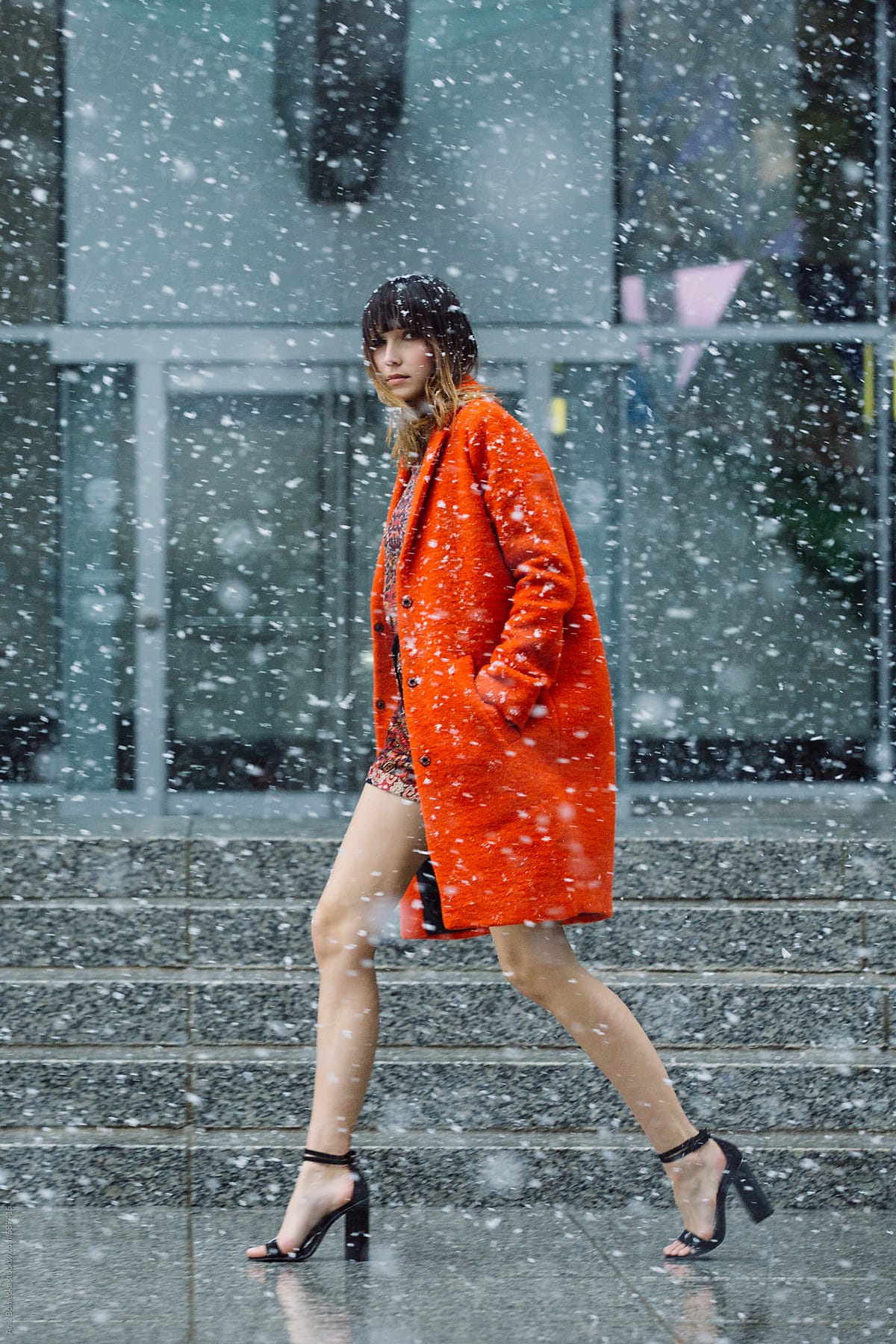 Bright orange jacket in the falling snow