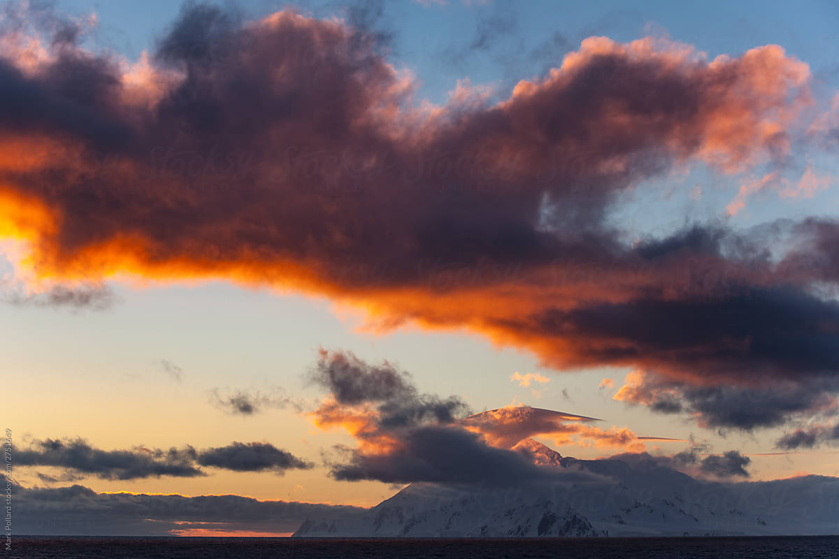 Dramatic Red Hued Sunset with Snowy Peaks on Horizon