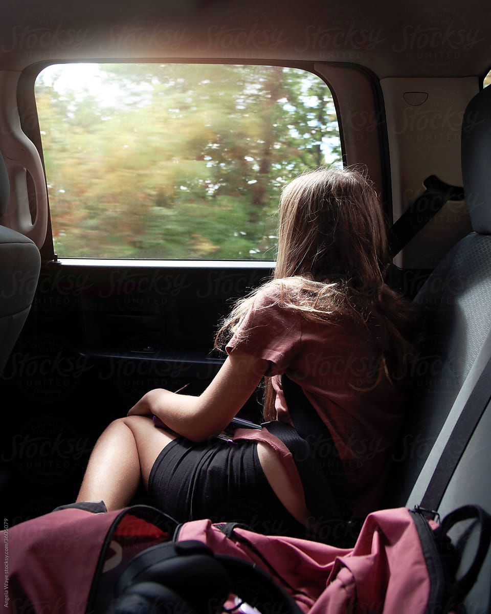 Girl Traveling in Car Ride Looking Out Window