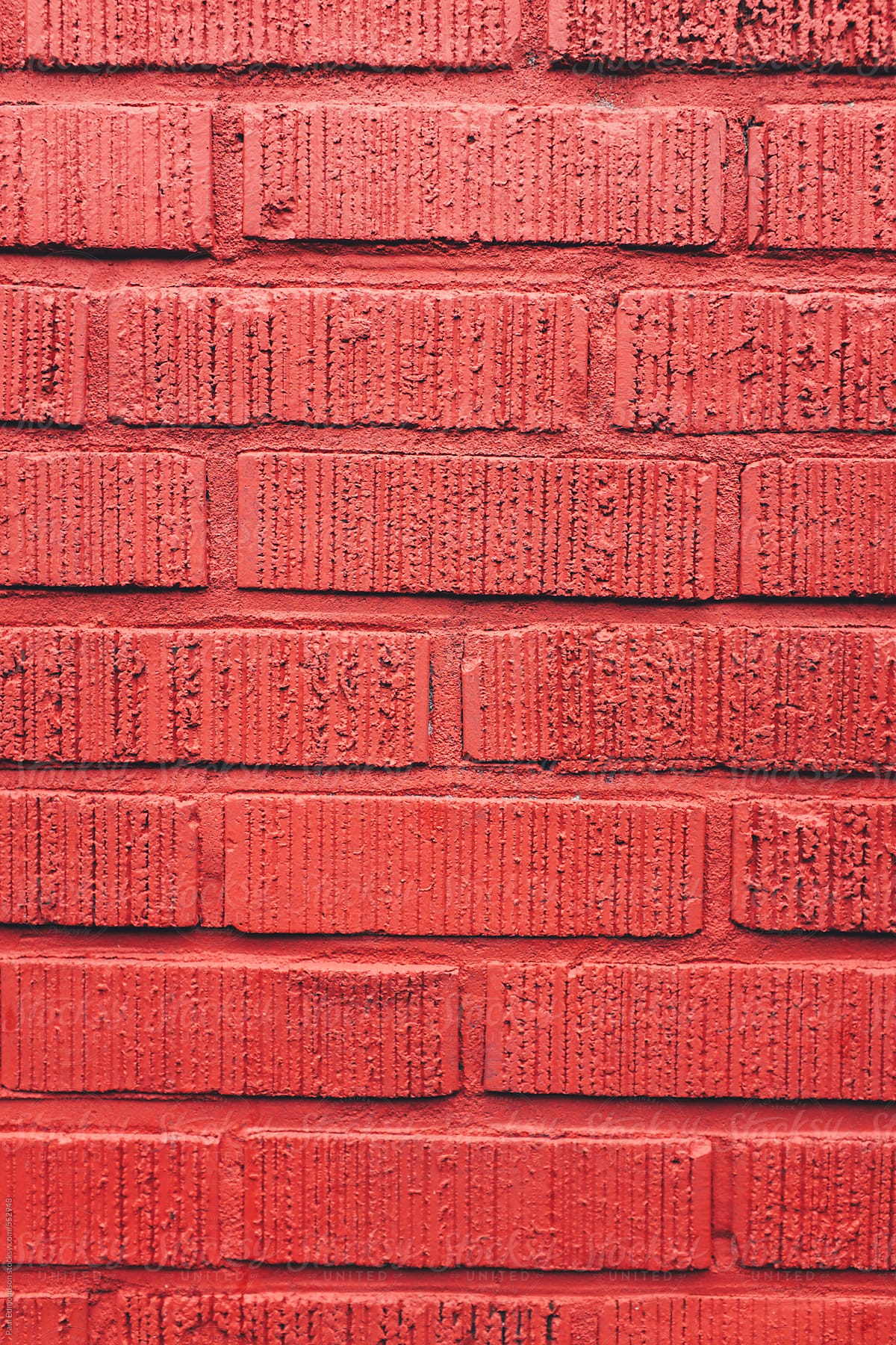 Bright red paint covering brick wall