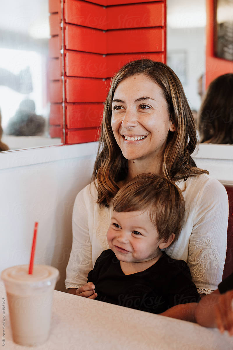 Smiling, Brunette Mom and Toddler at Ice Cream Parlor