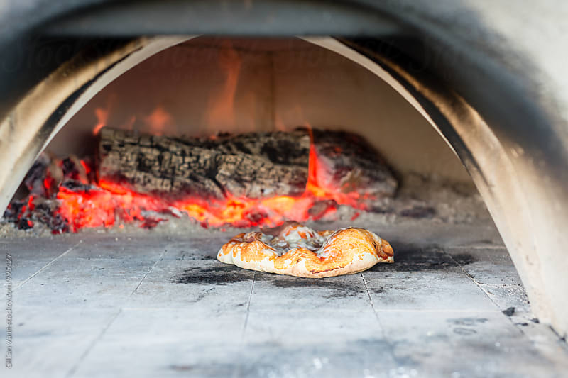 pizza cooking in a pizza oven