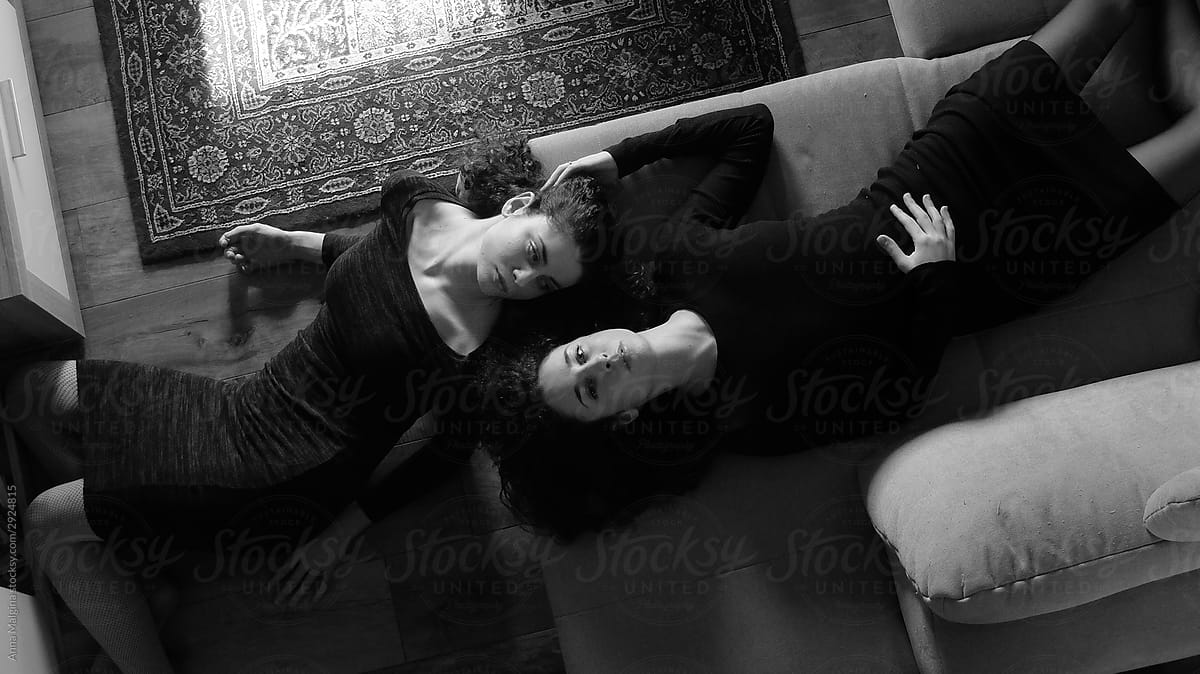 Two sisters lying on a sofa