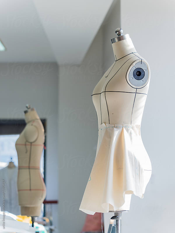 dressmaker unfinished dress craft on mannequin in studio