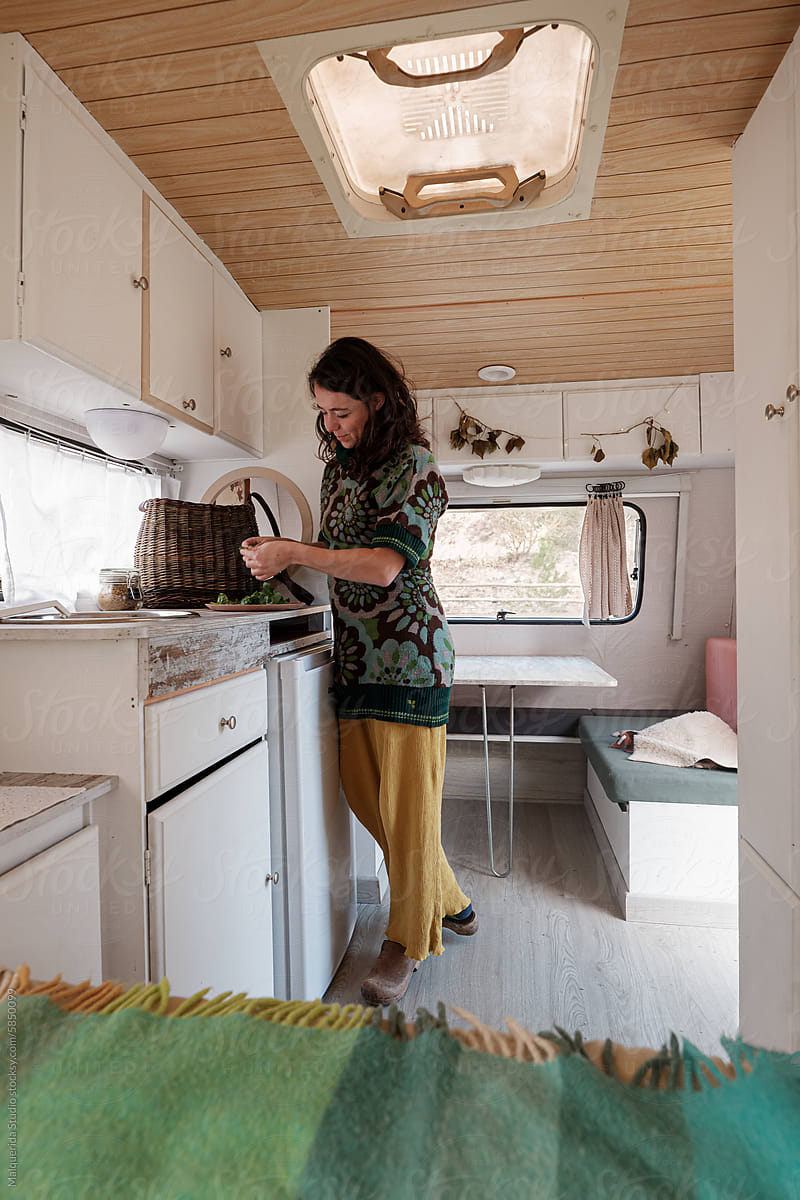 woman preparing meal in a caravan