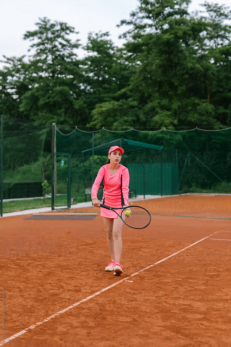 Young student playing tennis on the tennis court