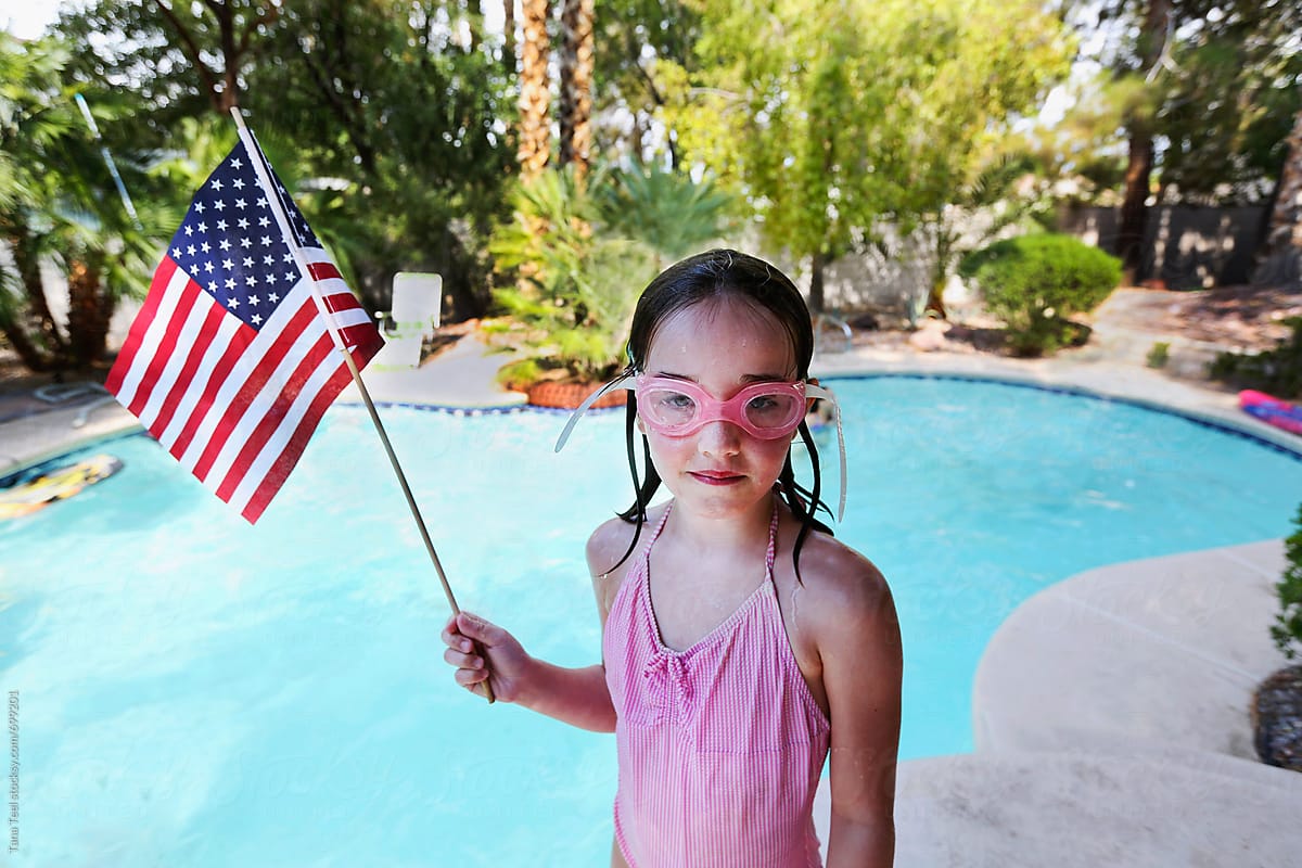 Young swimmer holds American flag