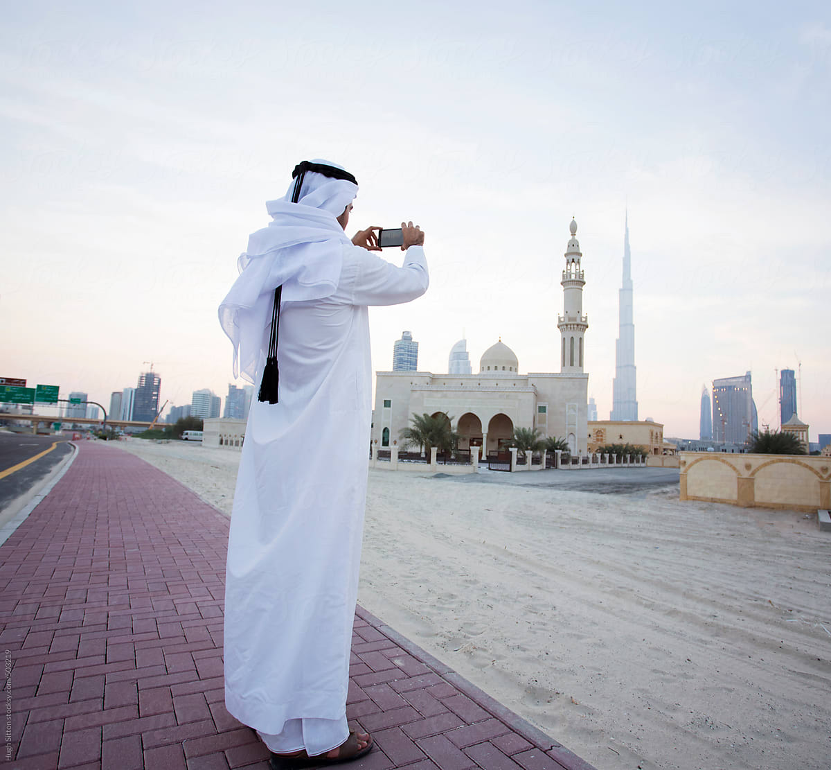 Arabian man viewing Dubai Business district. Dubai. U.A.E.
