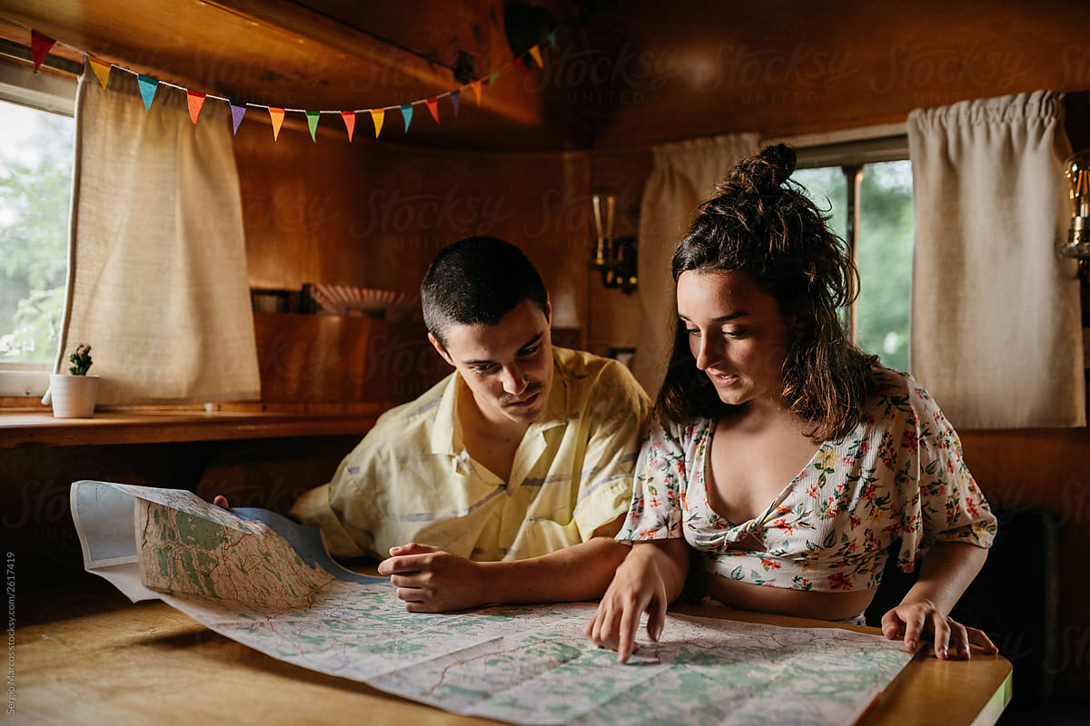 Couple reading map in camper