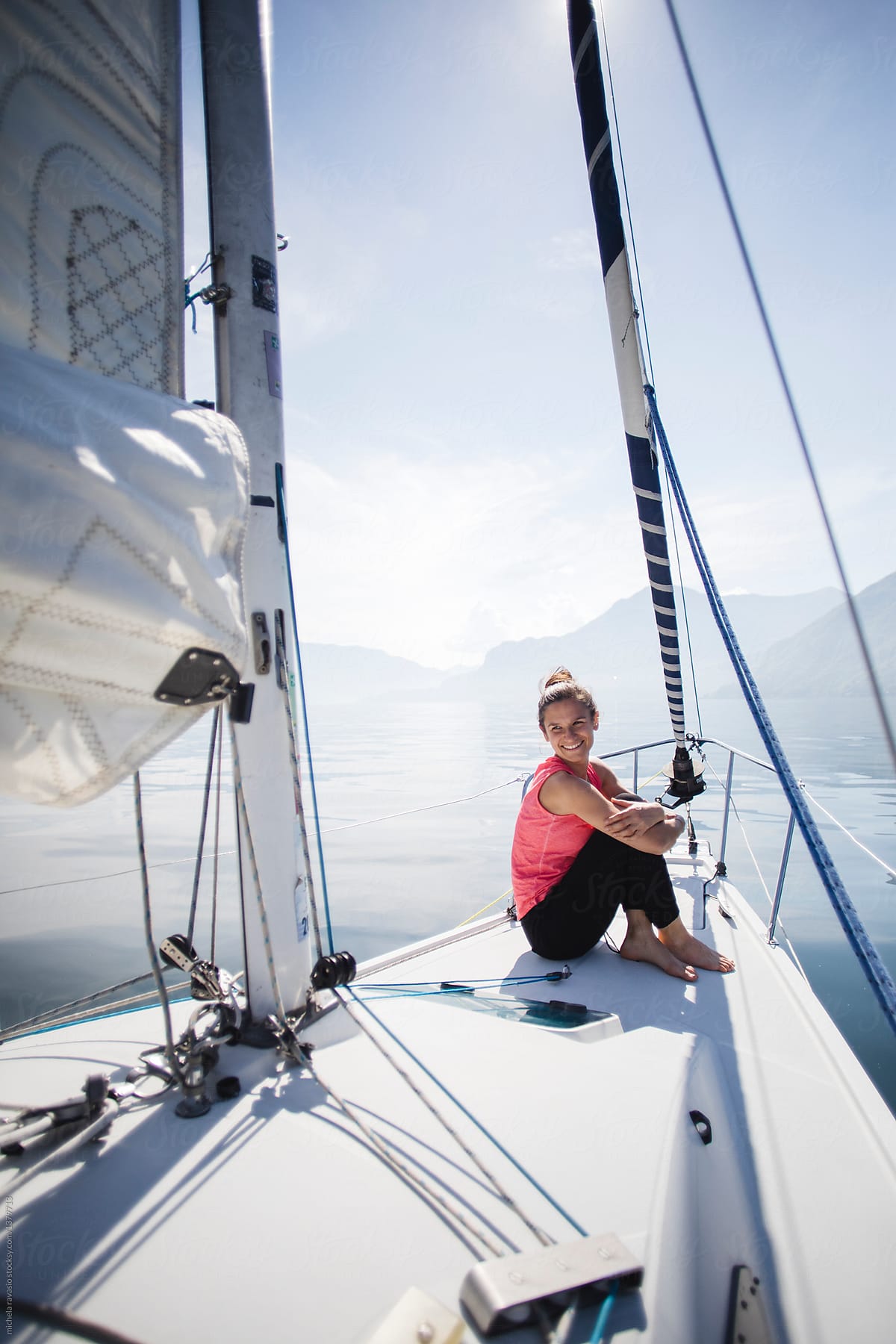 Smiling woman relaxes on a sail boat