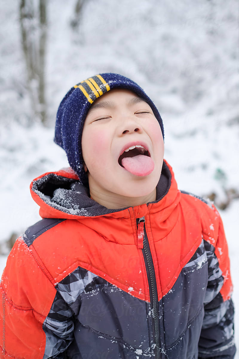 Asian Boy Playing With Snow in the Winter