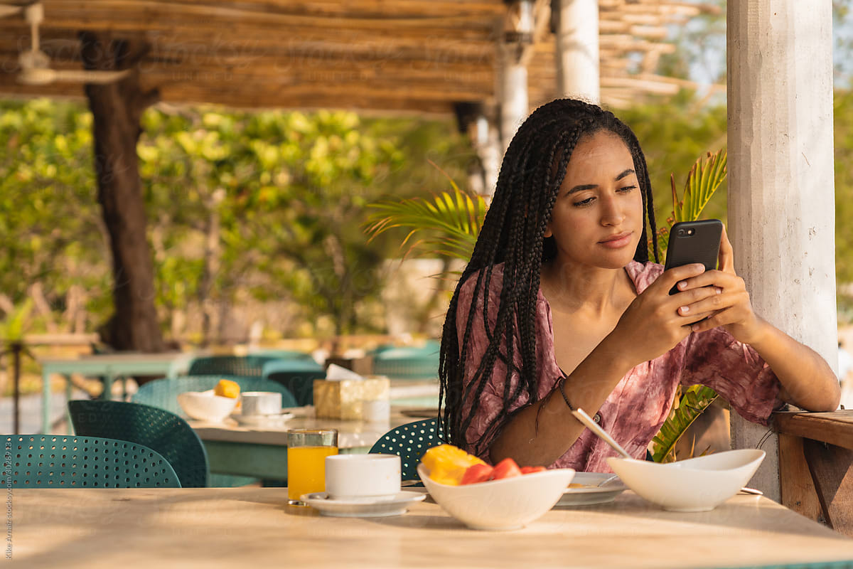 Black woman having breakfast on the beach