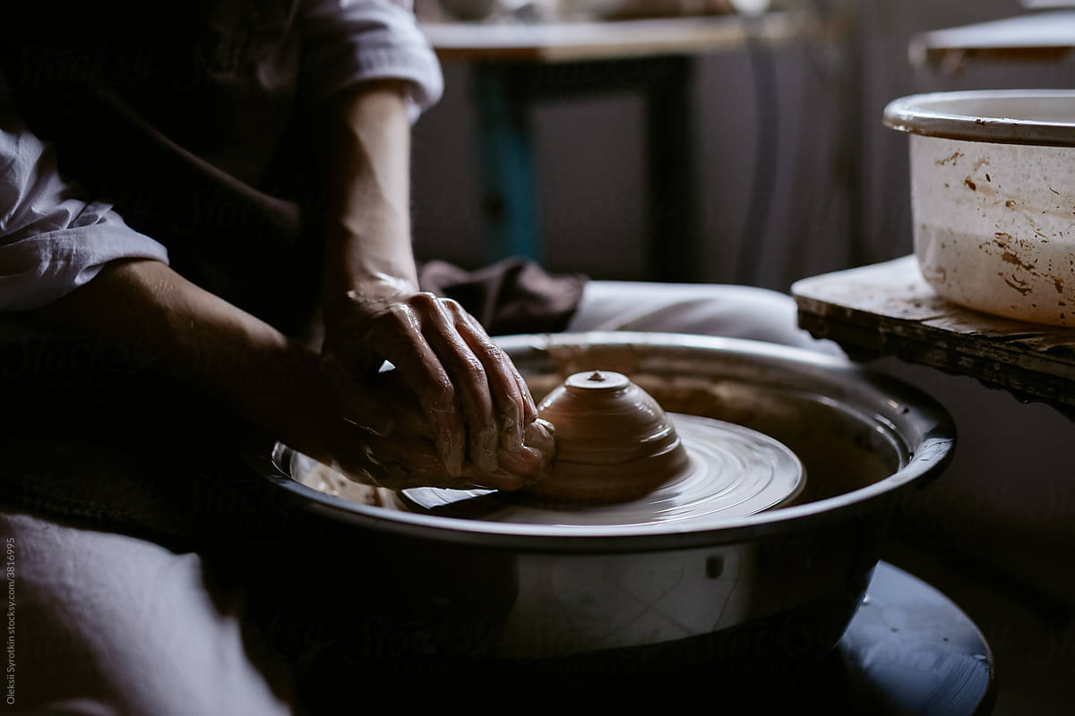 Potter making bowl in workshop