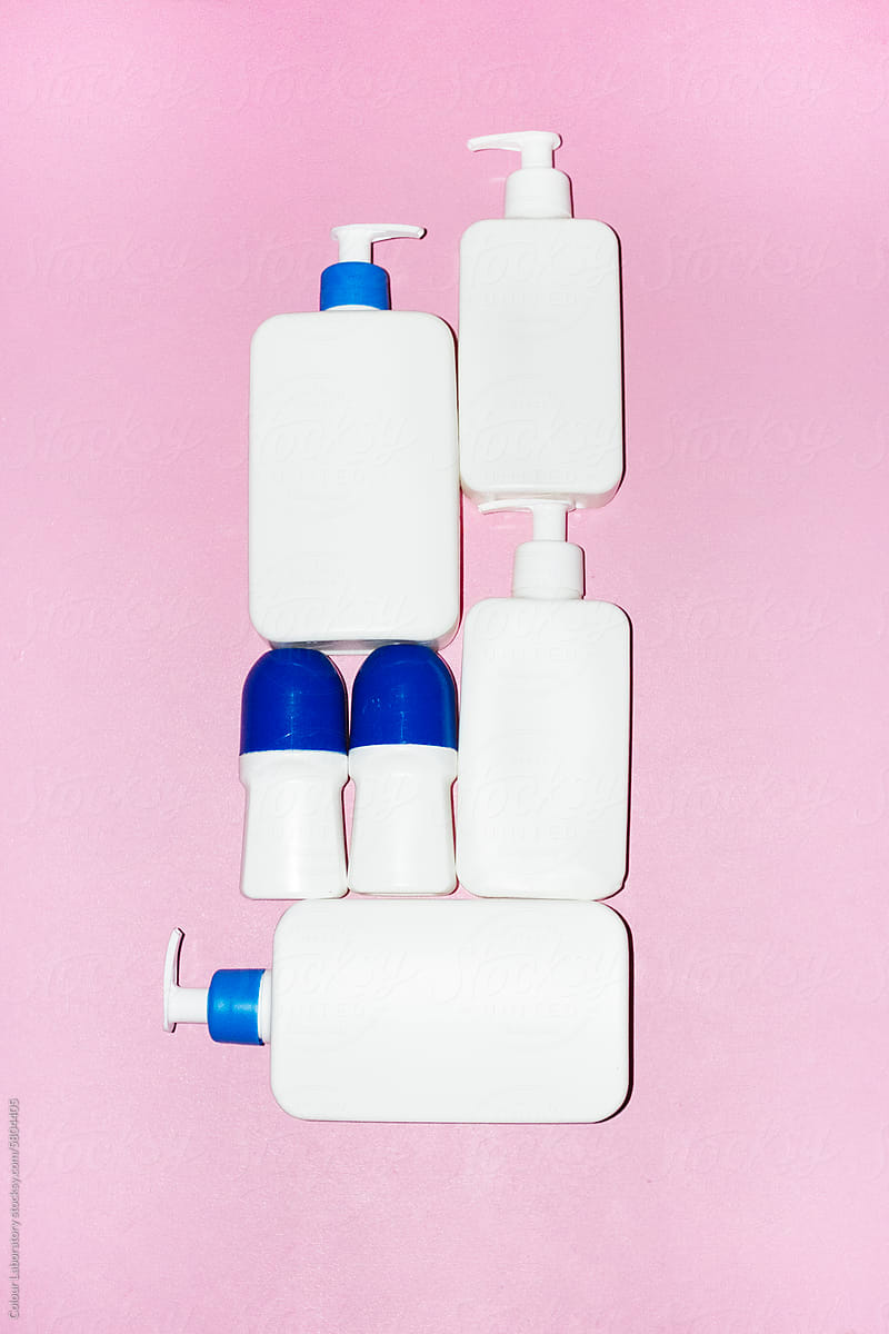 White plastic cosmetics lotion bottles with hard direct flashlight