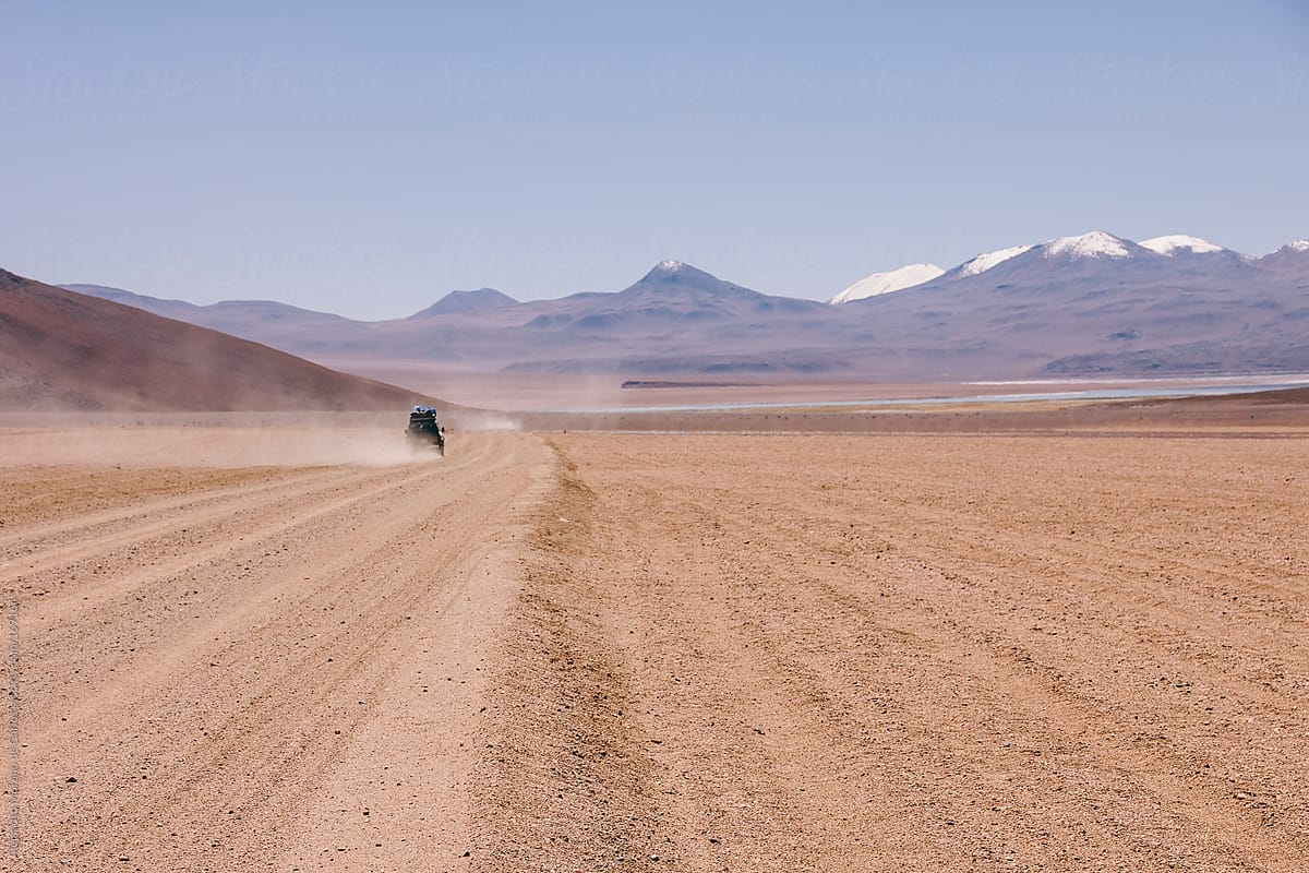 4wd Car On Desert Driving Offroad With Mountains On Background. Adventure  Travel In Bolivia