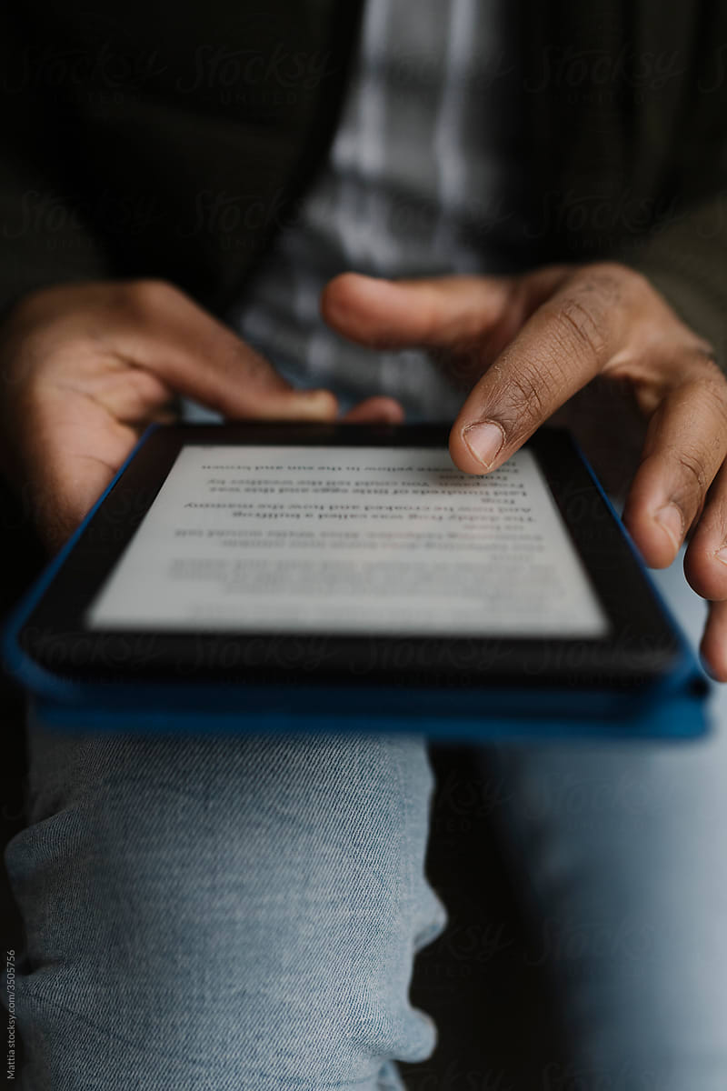 Black hands Holding an E-Book Tablet
