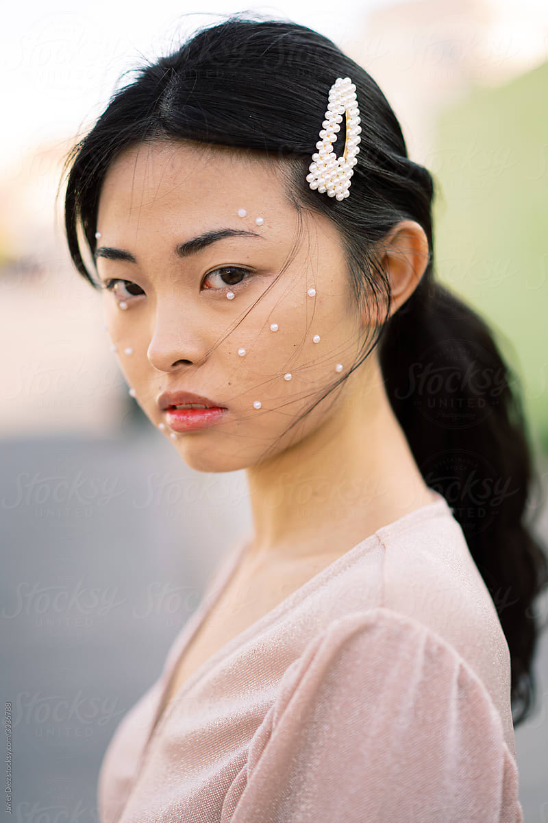 Stylish Asian female on city street