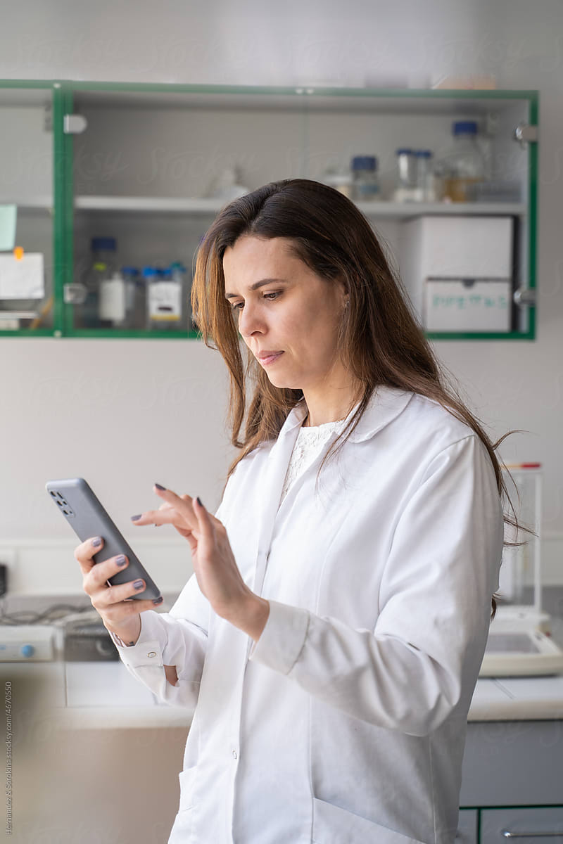 Woman Using Mobile Phone In Lab