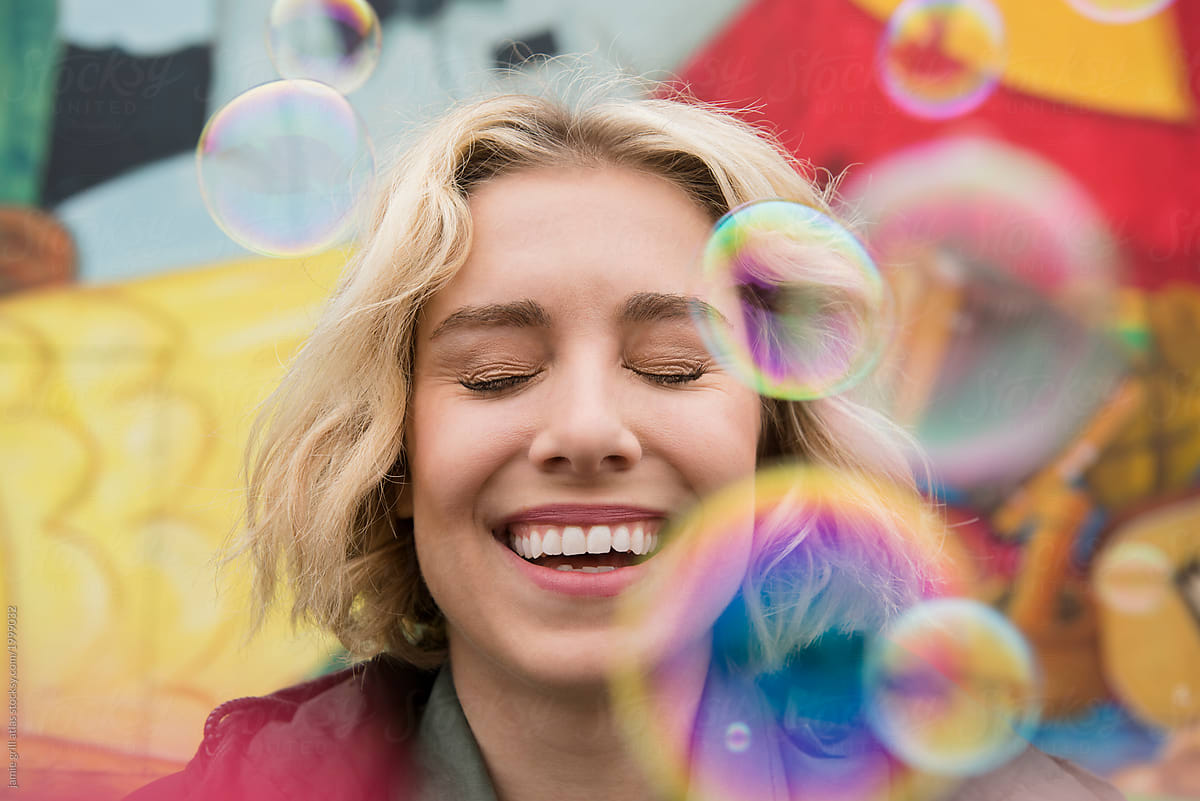 Woman Laughing Behind Bubbles By Stocksy Contributor Jamie Grill Atlas Stocksy 
