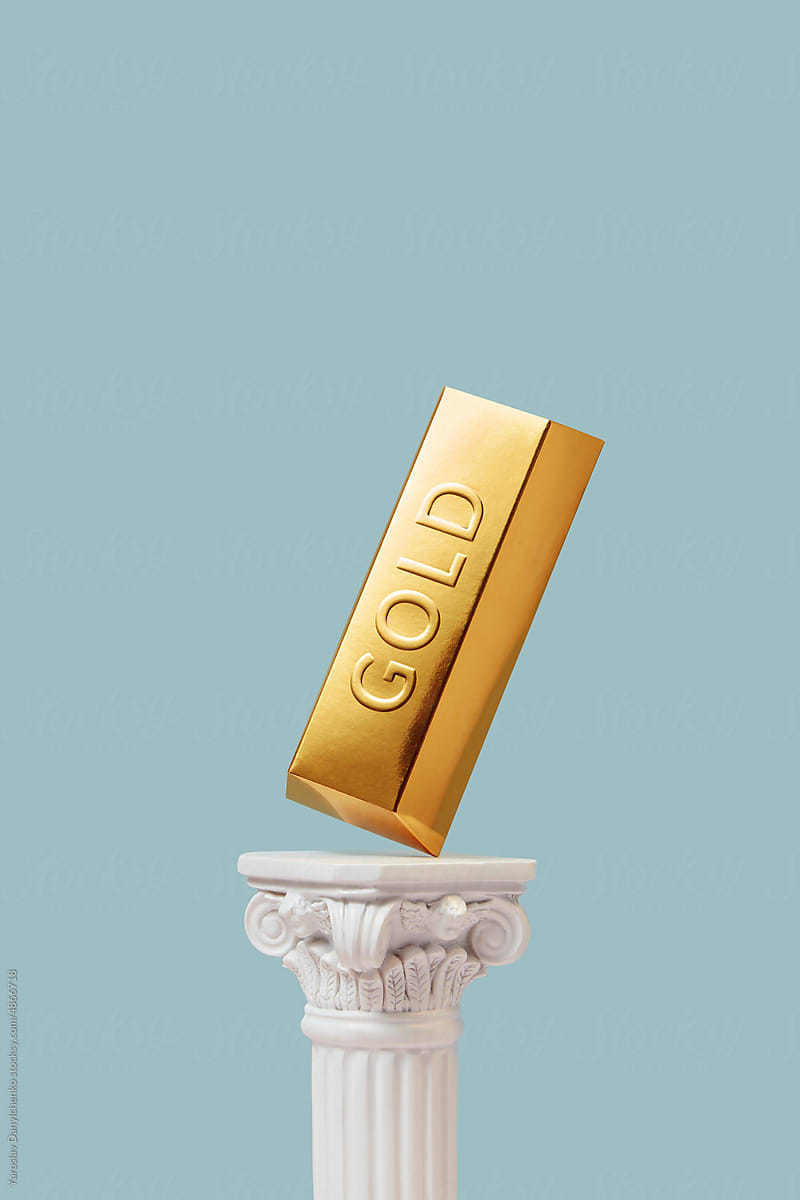 Gold ingot on white column.