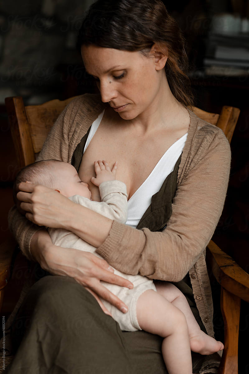 Mother Breastfeeding Her Baby Girl by Stocksy Contributor Studio Serra -  Stocksy