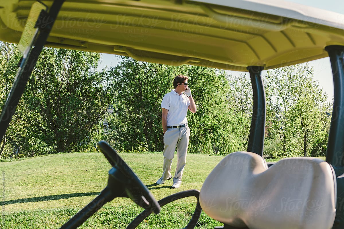 Young Man in a Golf Course Talking by Phone