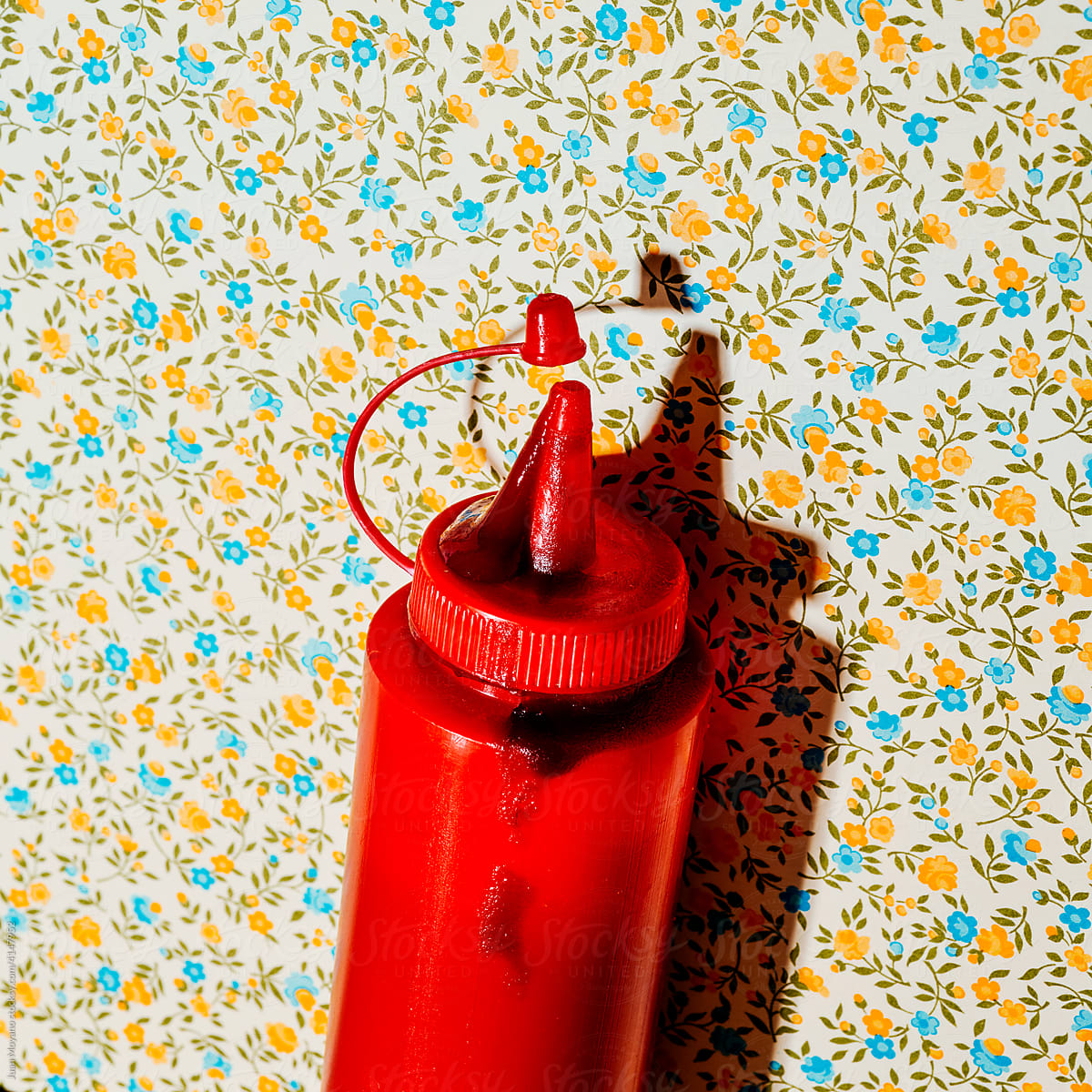 dirty ketchup bottle on a floral background