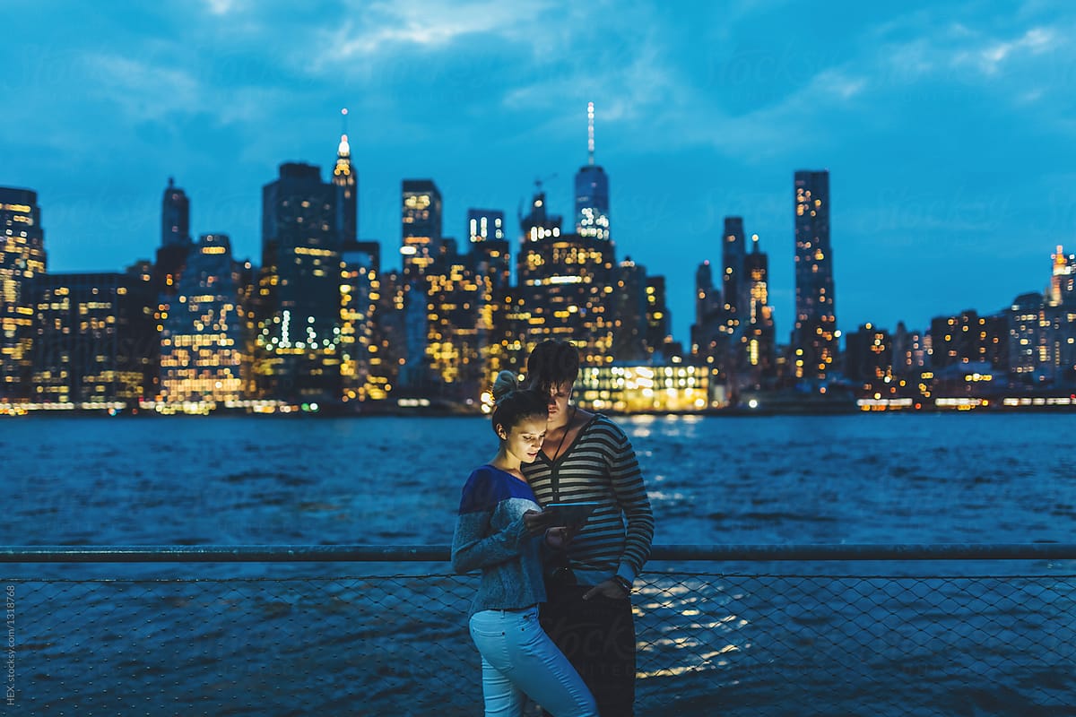 Young Couple Discovering New York City By Night With A Digital Tablet Us By Stocksy
