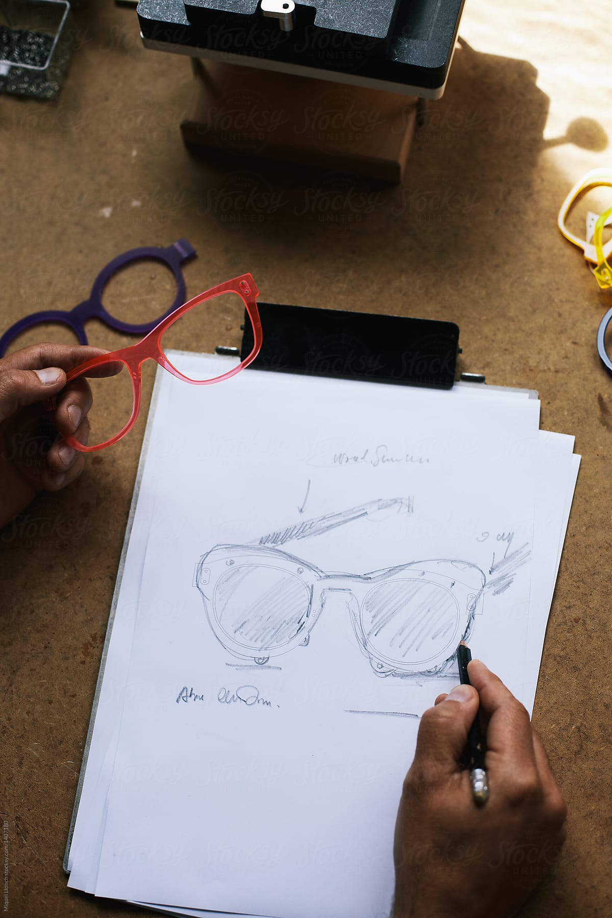 Artisan designer at work with some eyewear sketches