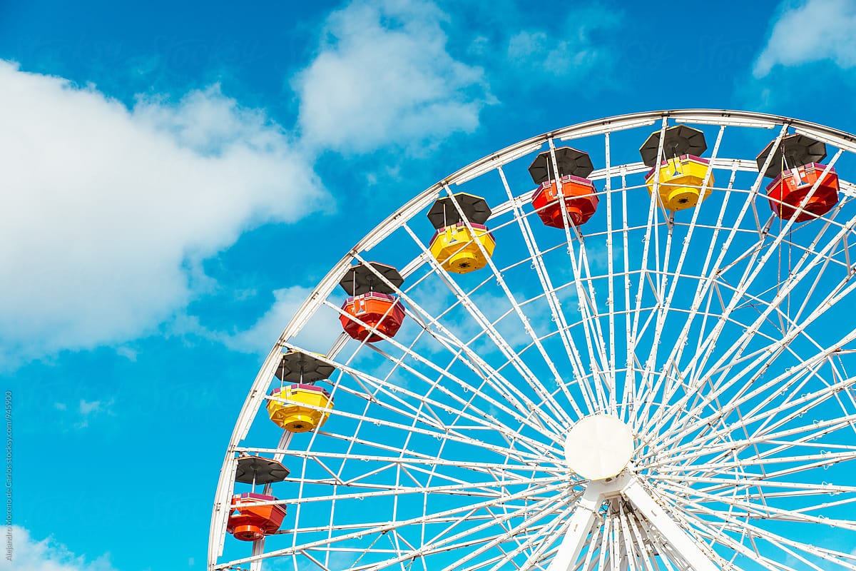 Detail of colourful ferris wheel against blue sky in summer