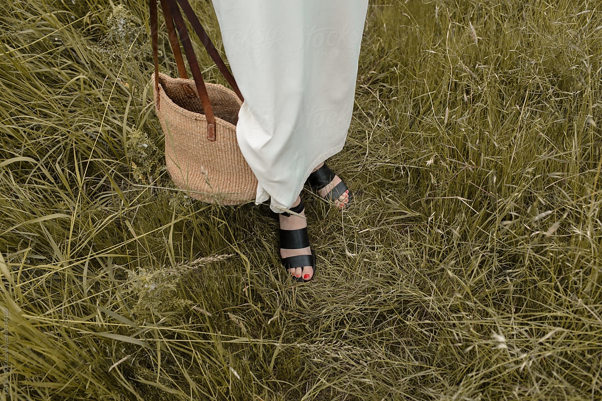 Woman\'s feet in tall grass