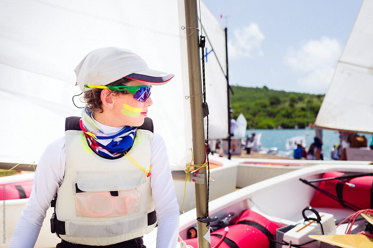 Boy in sailing gear waiting to launch at a sailing regatta