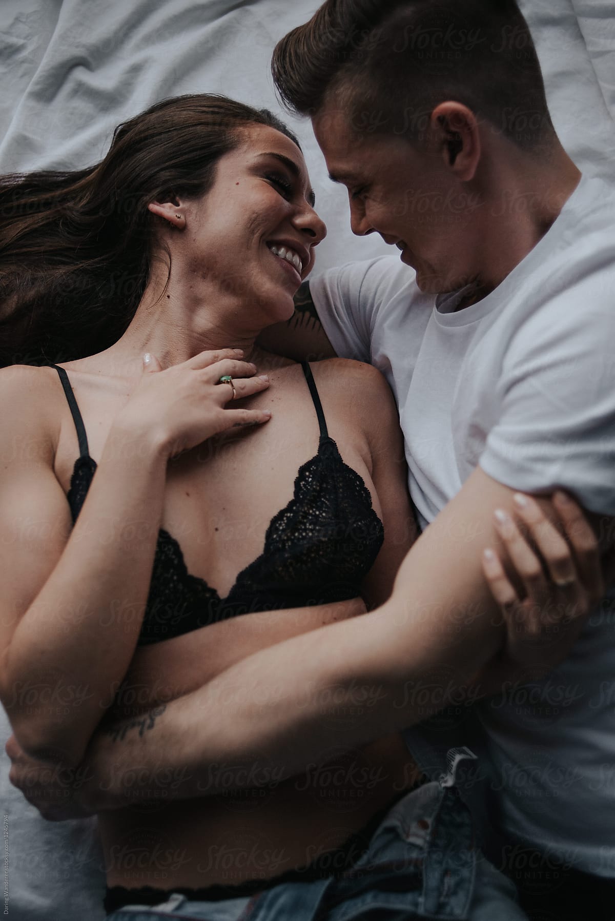 Young Attractive Couple In Love Cuddling In Bed In Bra And Tshirt by  Stocksy Contributor Jess Craven - Stocksy