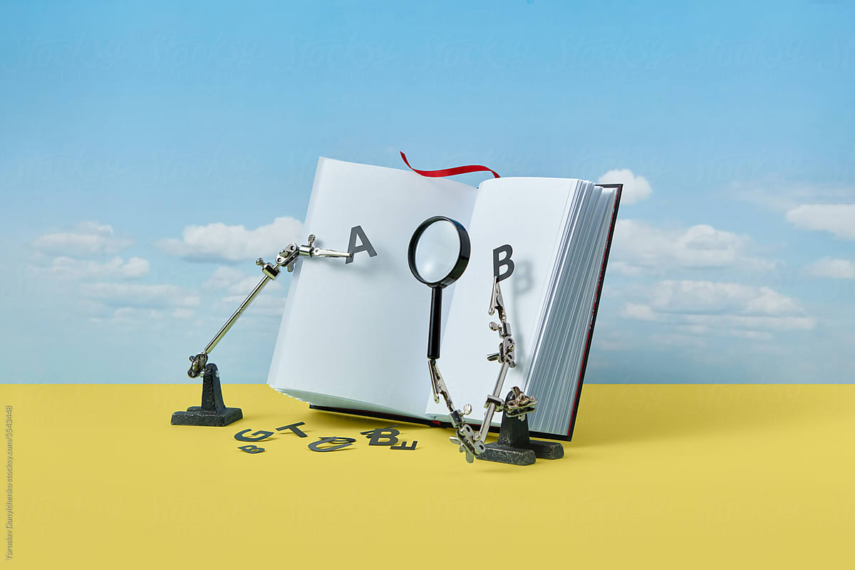 Book with magnifying glass and letters A and B.