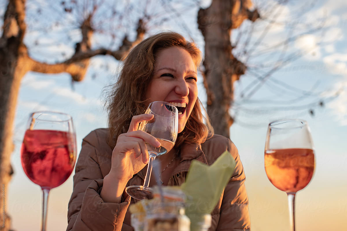 Cheerful smiling young woman drinking a wine