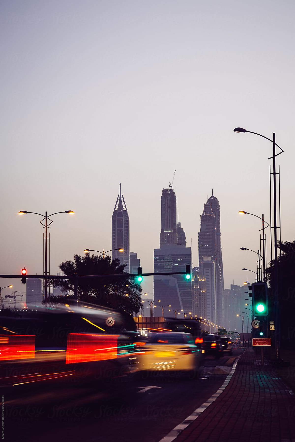 Tall buildings and traffic in Dubai at sunset