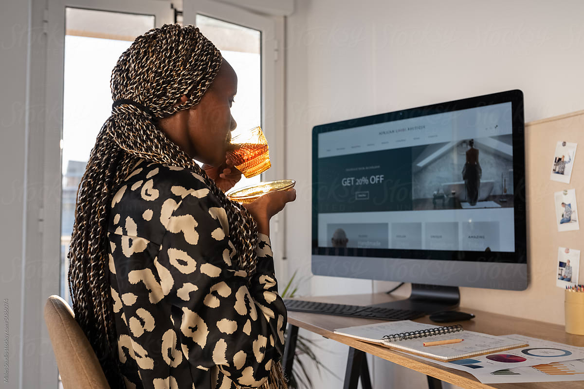 Black female freelancer drinking tea during break