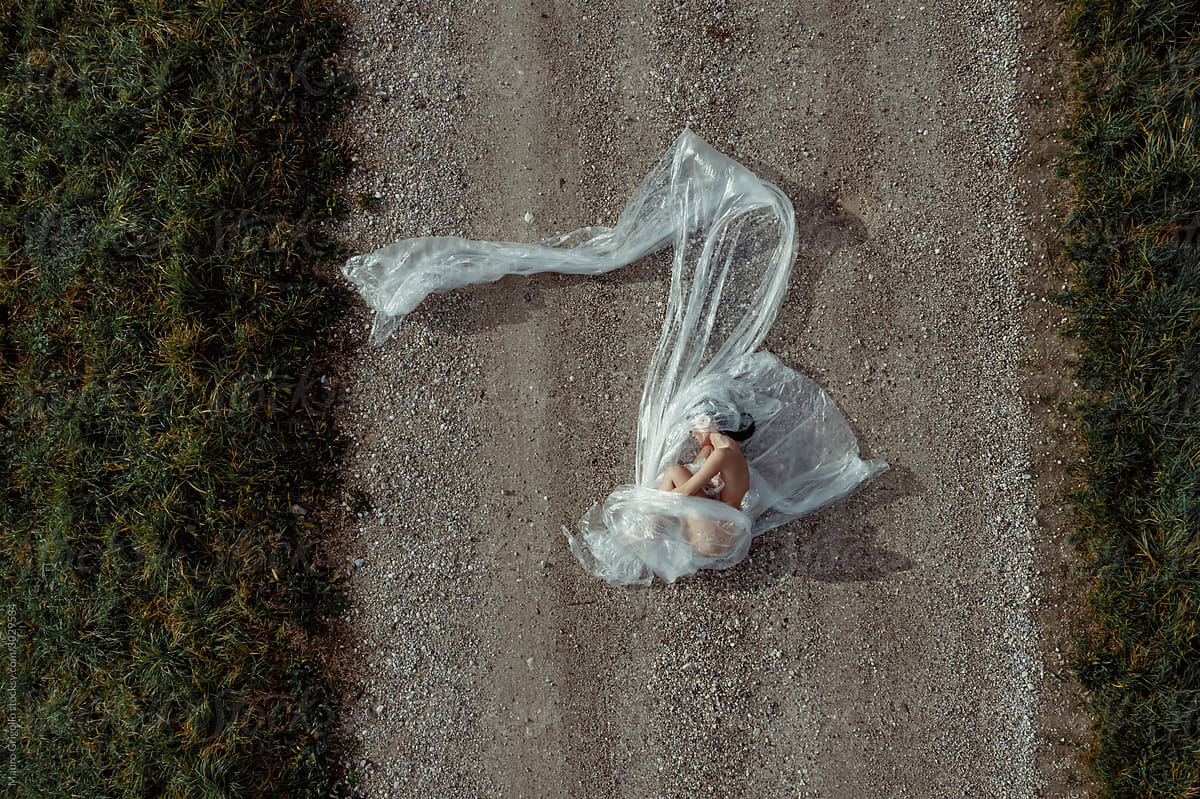 Aerial view of a woman covered with plastic