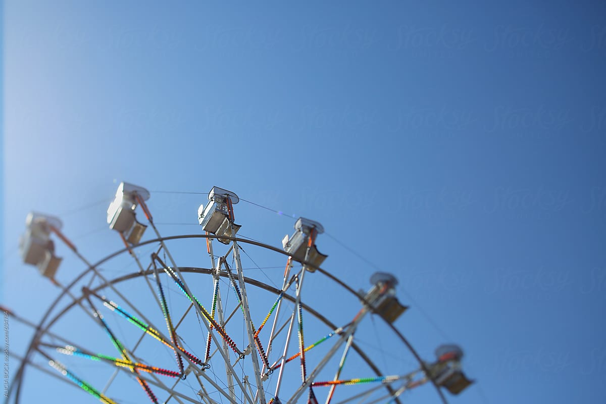 A Spinning Ferris Wheel At A Summer Fair