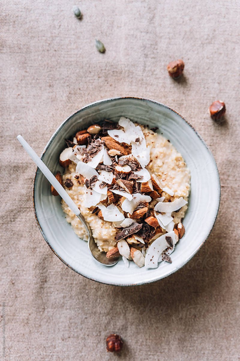 Delicious homemade porridge with nuts, shredded coconut and choc