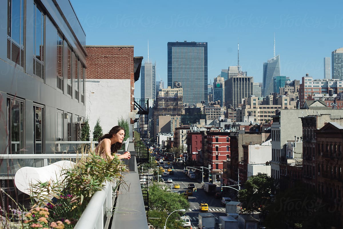 Woman looking at city skyline from deck