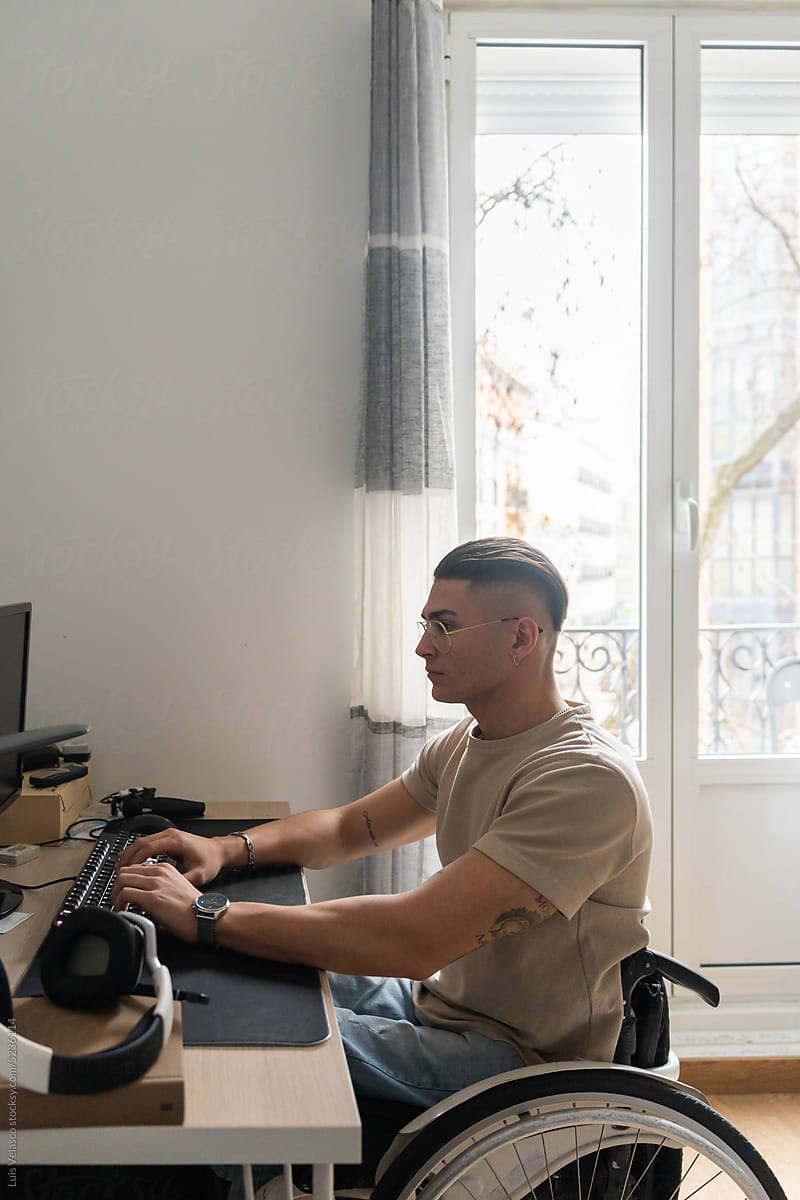 Young Adult Wheelchair User Using A Desktop Computer