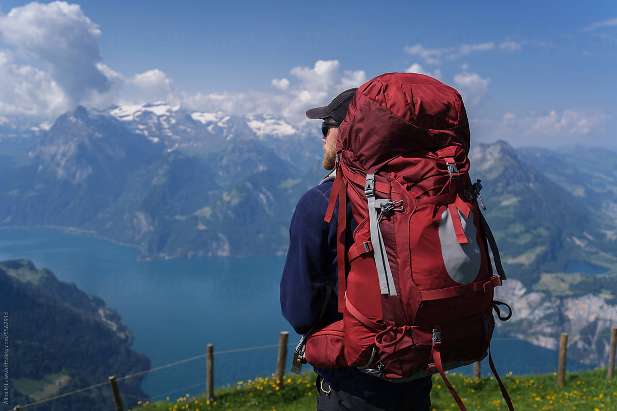 Portrait Of Backpacker On Mountain Range Background