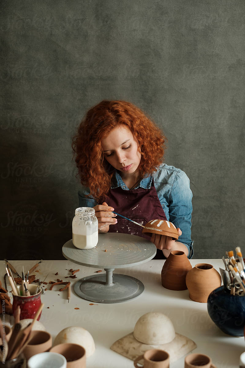 Redhead Caucasian Woman Working At The Pottery Studio
