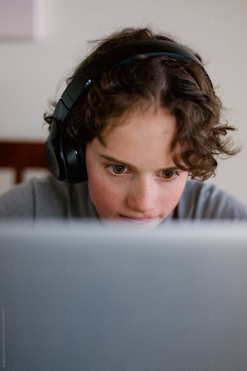 Boy with headphones and a computer screen