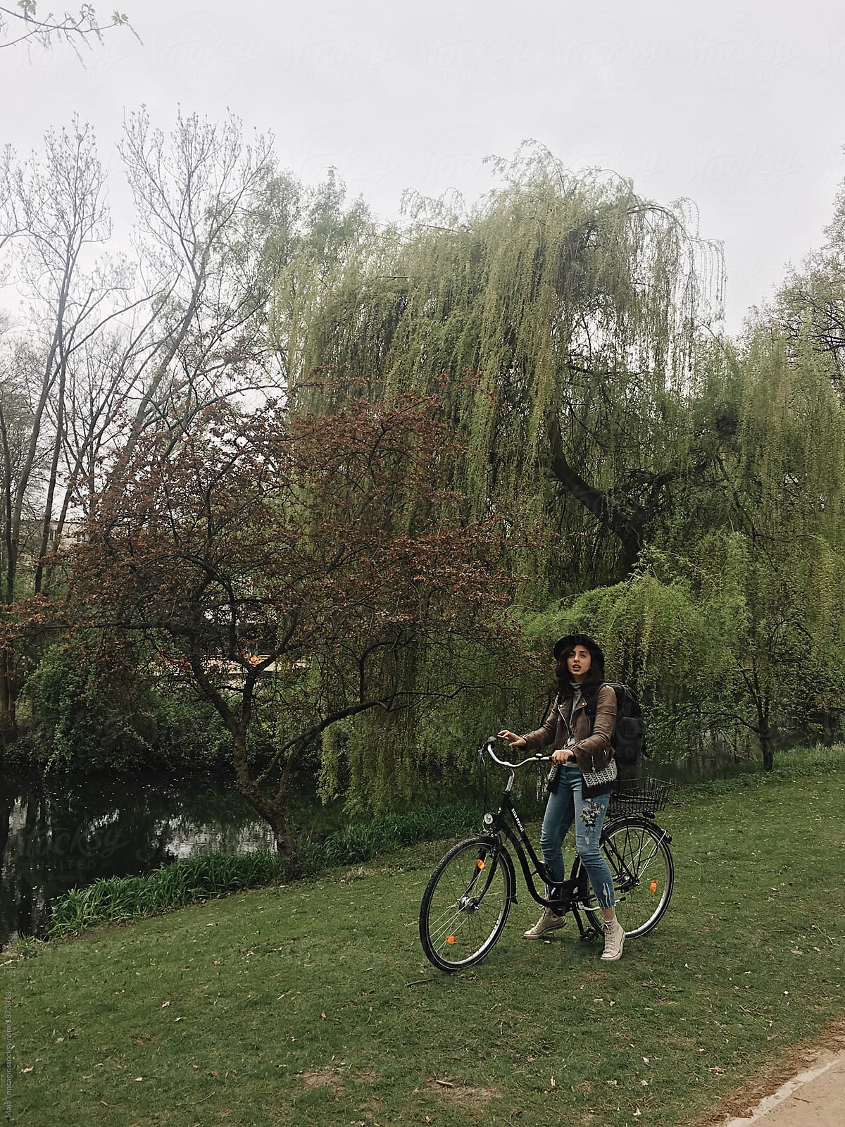 Woman riding a bicycle through park