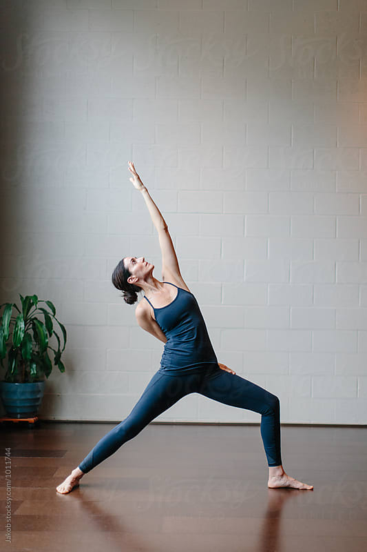 Beautiful woman practicing yoga in a studio