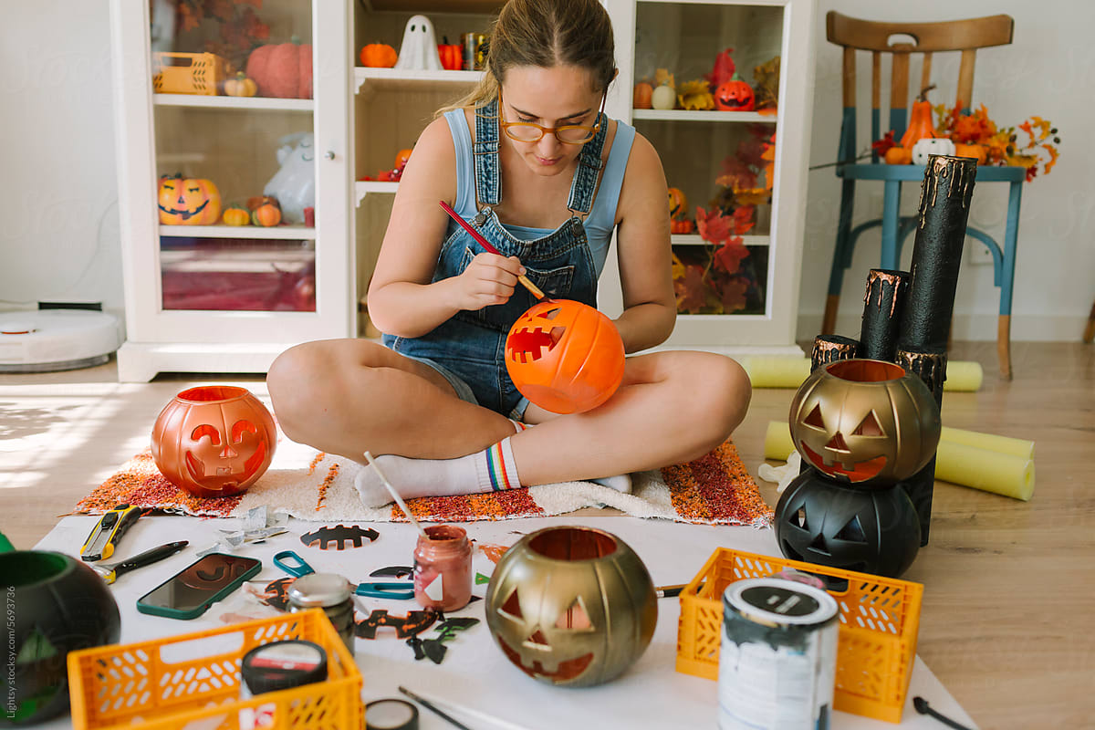 Woman doing a DIY of a Halloween pumpkin