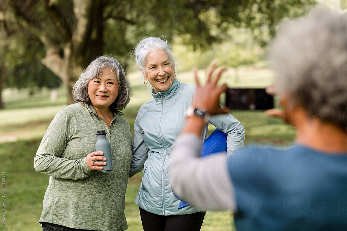 Senior Women Pose While Friend Takes Their Photo By Stocksy Contributor Mckinsey Jordan