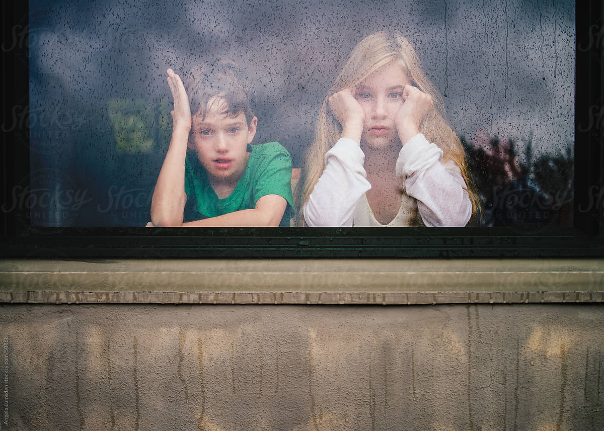 Children Looking Out A Window On A Rainy Day by Stocksy Contributor Angela  Lumsden - Stocksy